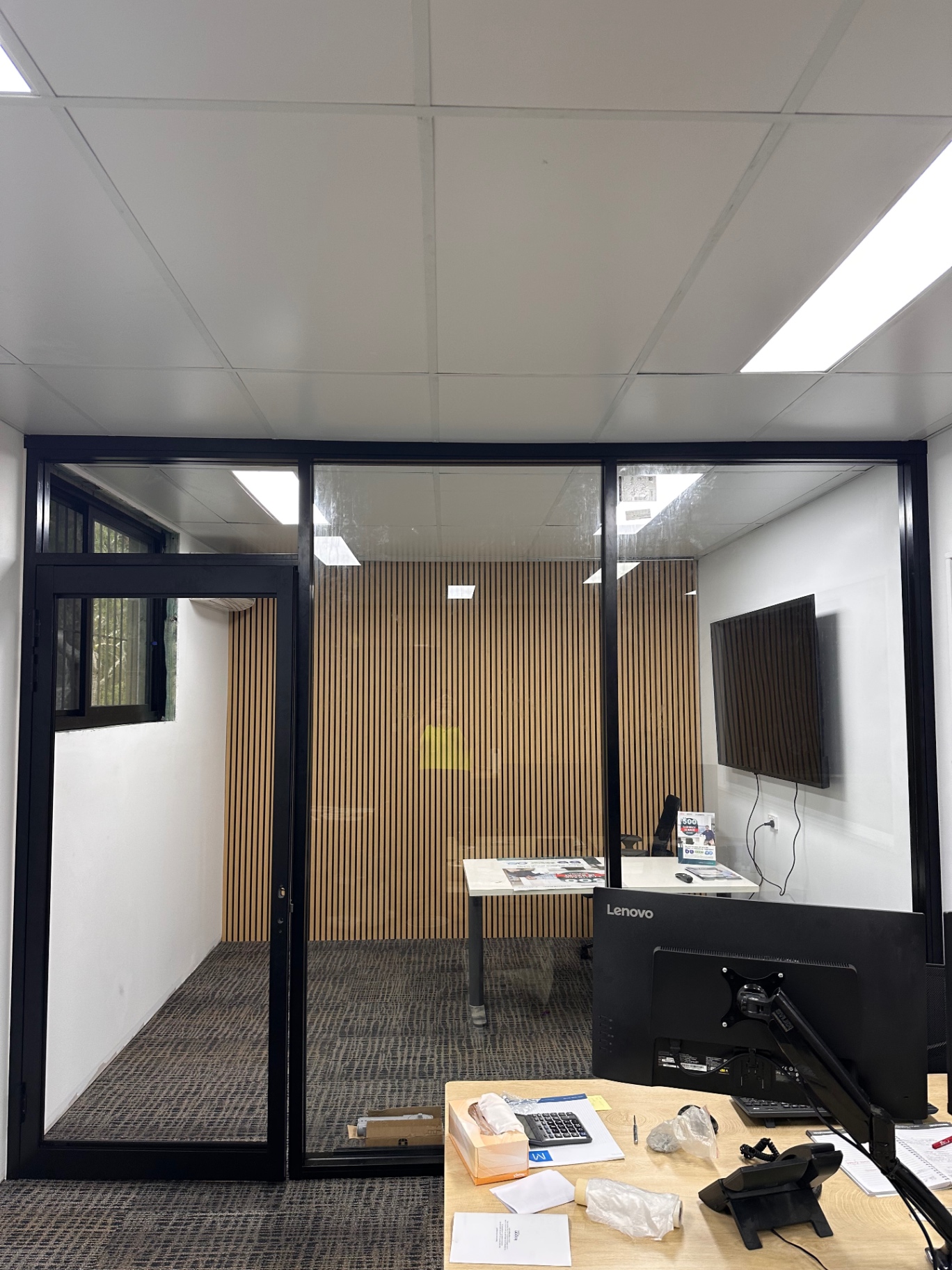 Completed black-framed glass partition and door in a commercial office